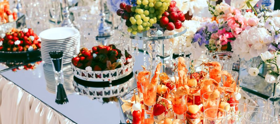 wedding catering with fruits and snacks on the decorated table